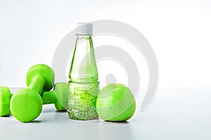 Organic food and sport equipment on light grey background with copy space.