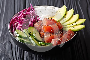 Organic food: tuna poke bowl with rice, fresh cucumbers, red cab photo