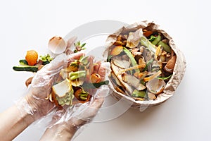 Organic food waste in paper bag and in hands