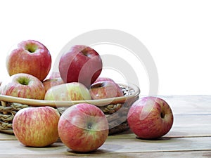 Organic Fresh apples in basket on wooden table isolated on white background