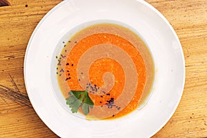 Organic fresh carrot and pumpkin soup with sesame seeds