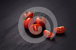 Organic fresh cherry tomatoes on black board background