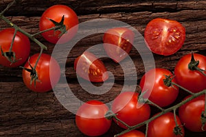 Organic fresh cherry tomatoes on wooden background