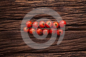 Organic fresh cherry tomatoes on wooden background