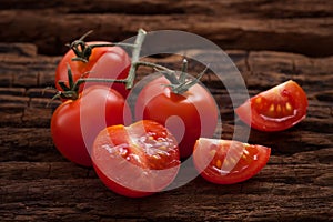 Organic fresh cherry tomatoes on wooden background