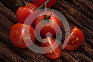 Organic fresh cherry tomatoes on wooden background