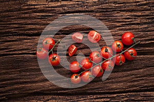 Organic fresh cherry tomatoes on wooden background