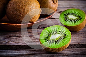 Organic fresh juicy kiwi on dark wooden background