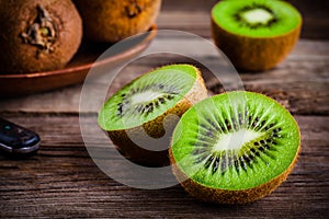 Organic fresh juicy kiwi on dark wooden background