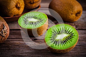 Organic fresh juicy kiwi on dark wooden background