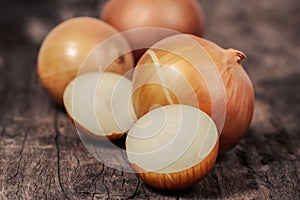 Organic fresh ripe onion on wooden background