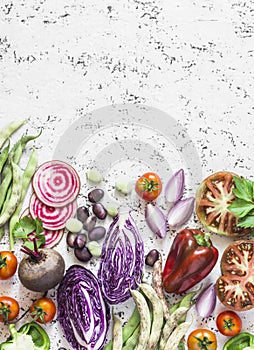 Organic fresh vegetables background. Cabbage, beets, beans, tomatoes, peppers on a light background, top view.