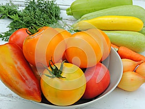 Organic fresh vegetables for preparing food on linen tablecloth, vintage wooden background.