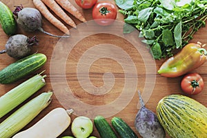 Organic fresh vegetables. Vegan healthy raw food on wooden table background. Top view, flat lay