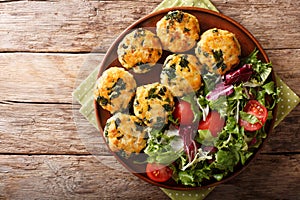 Organic fried meatballs with spinach and vegetable salad close-up. horizontal top view