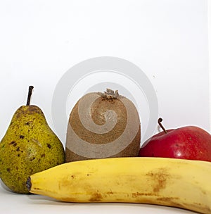 Organic fruits. Closeup apple, pear, kiwi, orange and banana on a white background with place for your text.