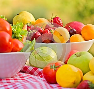 Organic fruits and vegetables in bowls - closeup