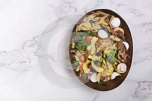 Organic garbage for compost on a marble background. Composting concept flat lay, top view