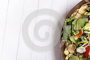 Organic garbage for compost on a wooden background with copy space. Composting concept flat lay, top view