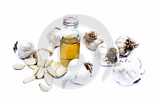 Organic Garlic oil in a transparent glass bottle isolated on white.