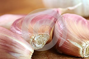 Organic garlic on wooden cutting board