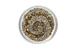 Organic Green tea (Camellia sinensis) Tea bag cut, dried leaves, in glass bowl.