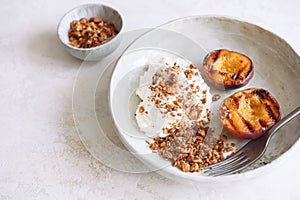 Organic grilled peaches served with stracciatella cheese and caramelized nuts crumb