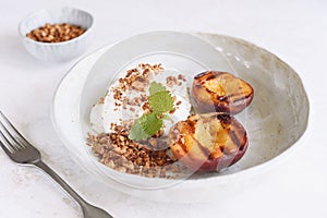 Organic grilled peaches served with stracciatella cheese and caramelized nuts crumb