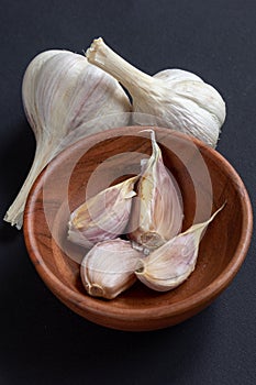 Organic grown garlic in a wooden bowl