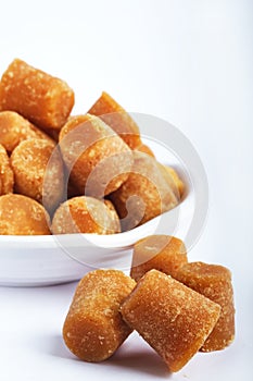 Organic Gur or Jaggery Powder and cubes, Jaggery is used as an ingredient in sweet and savoury dishes in the cuisines of India photo