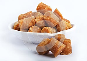 Organic Gur or Jaggery Powder and cubes, Jaggery is used as an ingredient in sweet and savoury dishes in the cuisines of India photo