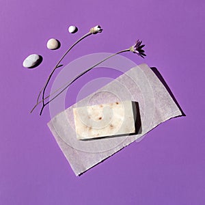 Organic handmade soap on a violet background sea stones