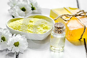Organic cosmetics with camomile extract on wooden table background