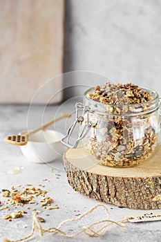 Organic homemade granola cereal with oats, nuts and dried berries. Muesli in a glass jar. Healthy vegan breakfast or snack. Copy