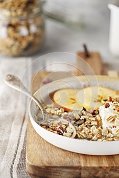 Organic homemade granola cereal with oats, nuts and dried berries. Muesli in a glass jar. Healthy vegan breakfast or snack. Copy