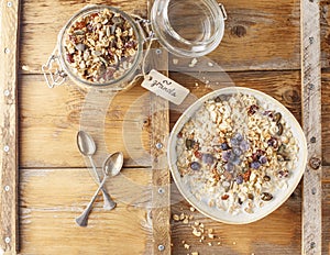 Organic homemade granola cereal with oats, nuts and dried berries. Muesli in a glass jar. Healthy vegan breakfast or snack. Copy