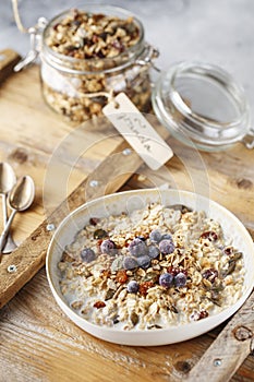 Organic homemade granola cereal with oats, nuts and dried berries. Muesli in a glass jar. Healthy vegan breakfast or snack. Copy