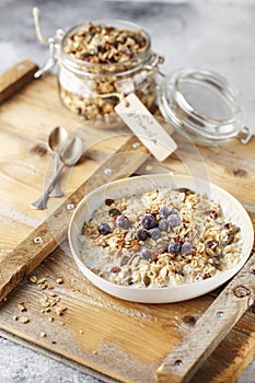 Organic homemade granola cereal with oats, nuts and dried berries. Muesli in a glass jar. Healthy vegan breakfast or snack. Copy