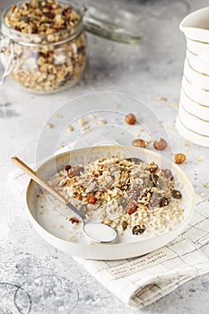 Organic homemade granola cereal with oats, nuts and dried berries. Muesli in a glass jar. Healthy vegan breakfast or snack. Copy