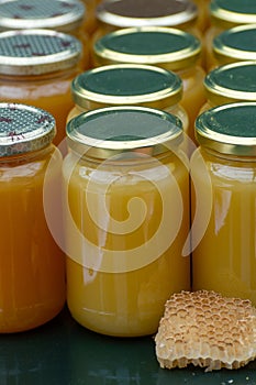 Organic honey from farm bee apiary on mountains meadows with summer wild flowers for sale in farm shop