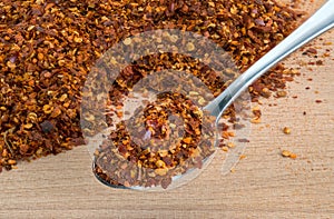 Organic Hot Red Chili Flakes on wooden cutting board