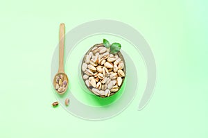 Organic ingredients in a coconut bowl for Flexitarianism or Flexible Vegetarianism on green background. Creative copy space