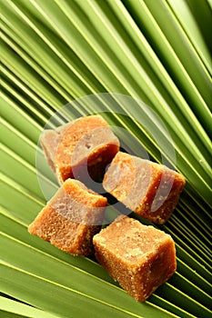 Organic jaggery cubes on palm tree leaf