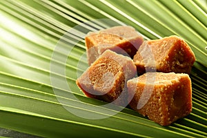 Organic jaggery cubes on palm tree leaf