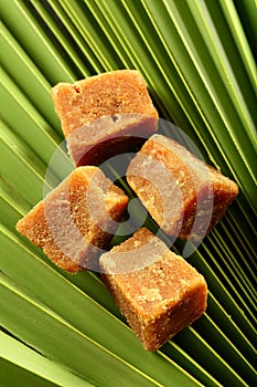 Organic jaggery cubes on palm tree leaf