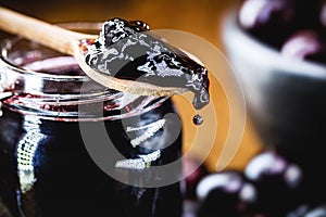 Organic jelly made in a wooden spoon, jabuticaba or jaboticaba jelly, a typical Brazilian fruit, known as Brazilian grape, photo