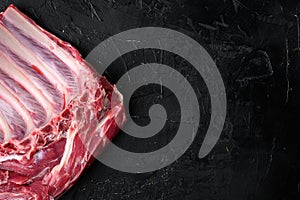 Organic lamb meat sheep or Mutton, on black dark stone table background, top view flat lay, with copy space for text