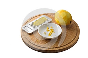Organic lemon fruit, freshly grated peel or rind and the grater