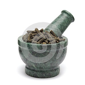 Organic Long pepper Dried Fruit (Piper longum) on marble pestle.