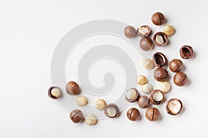 Organic macadamia nuts on white table top view.